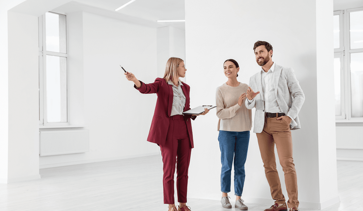 Real estate agent with couple in house