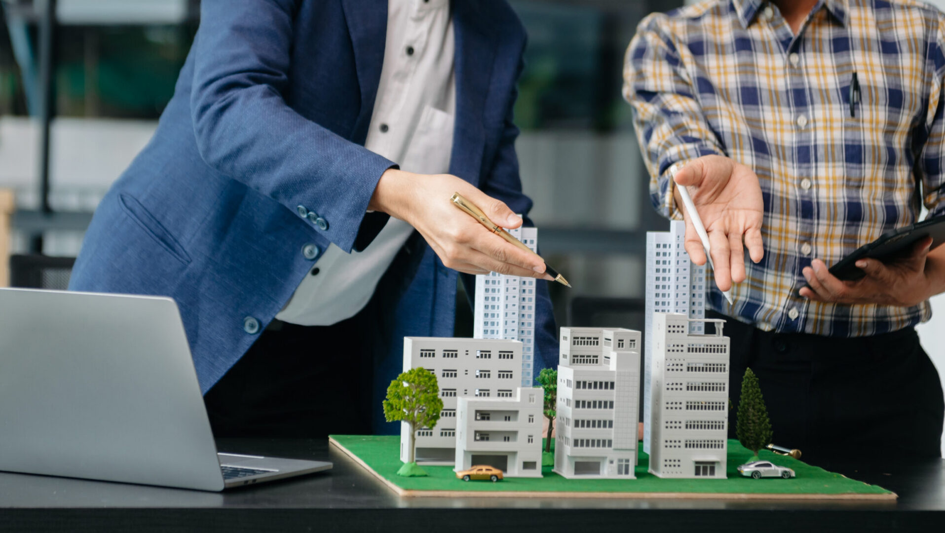 balancing the property sector The real estate agent is explaining the house style to see the house design and the purchase agreement. house at office