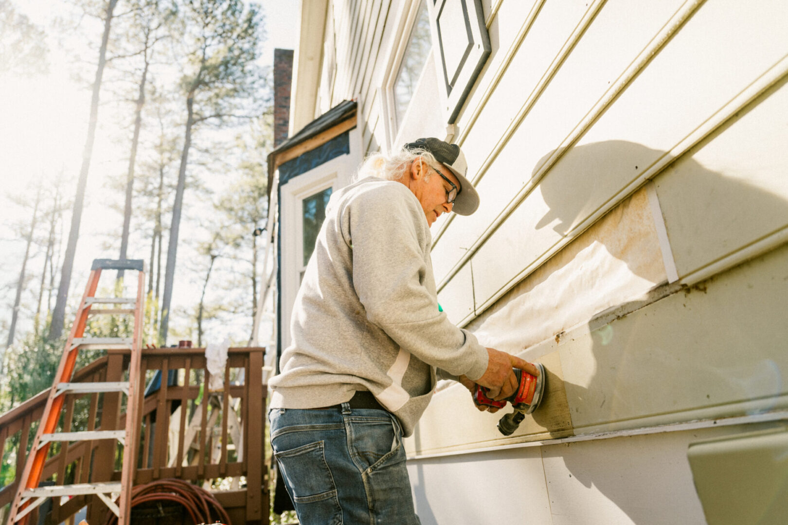 Construction worker repairing a colonial style house siding
